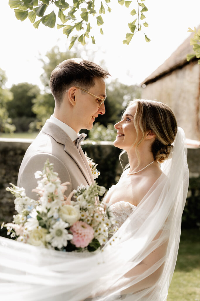 Braut und Bräutigam schauen sich lächelnd an, natürliches Brautpaarshooting