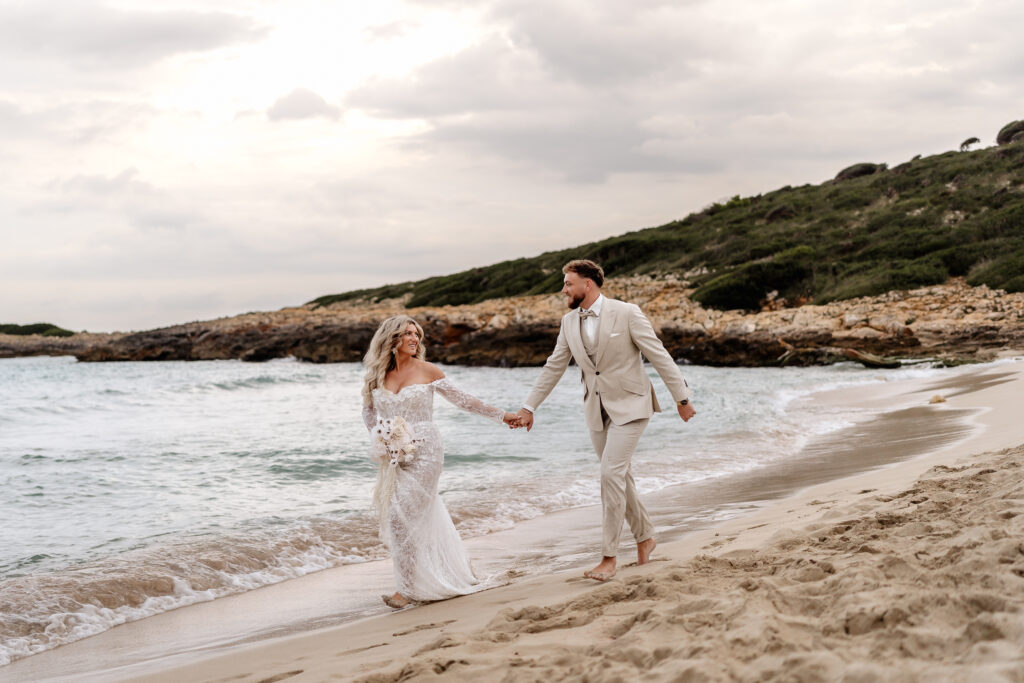 Brautpaar läuft glücklich am Strand während dem After-Wedding-Shooting auf Mallorca